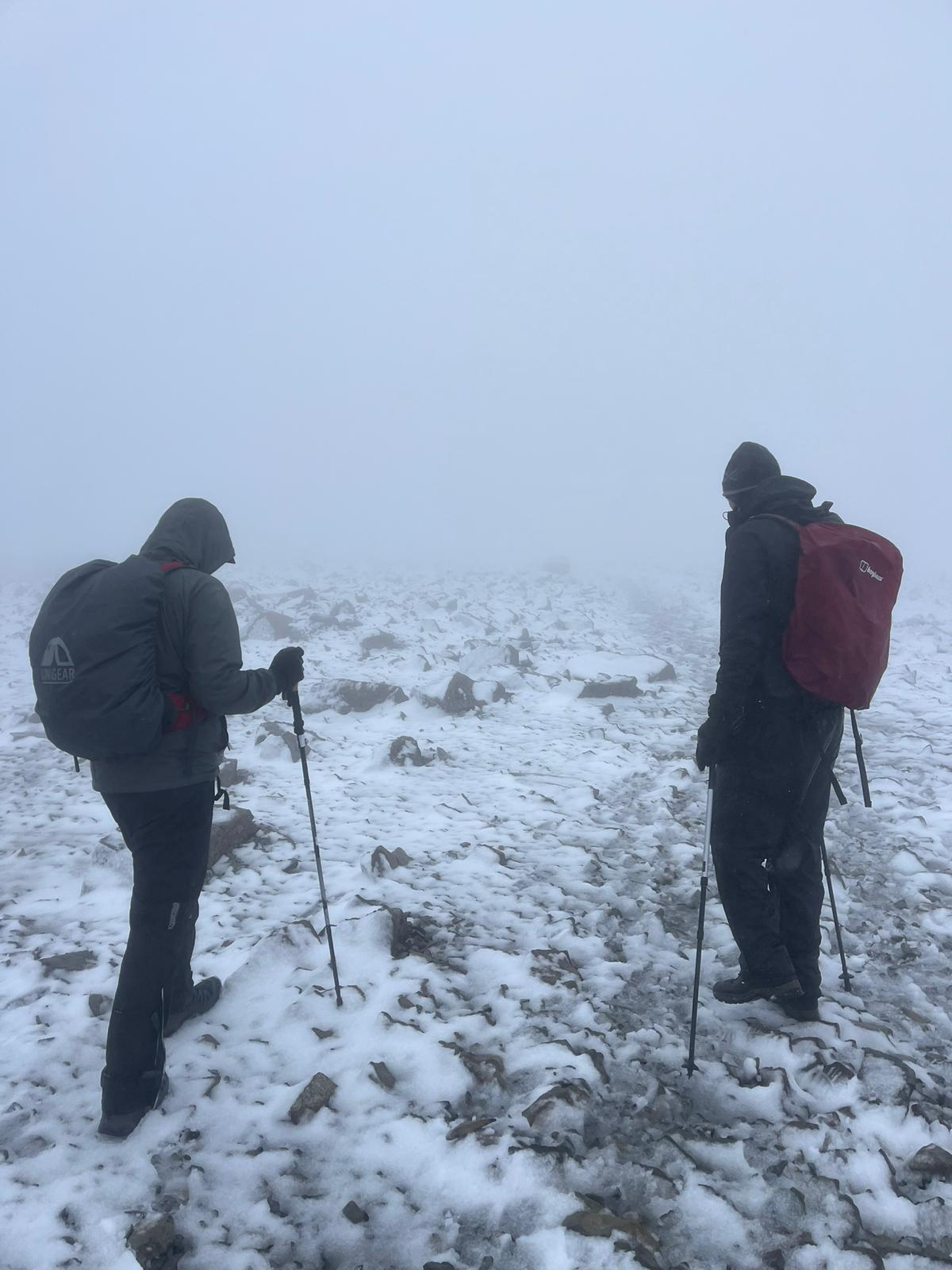 two people climbing in the snow